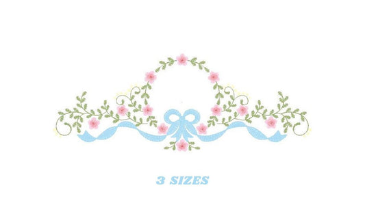 May include: Embroidered design featuring a wreath of pink flowers with green leaves and a blue ribbon bow. The text "3 SIZES" is below the design.
