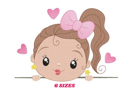 May include: Embroidered design of a girl with brown hair, a pink bow, and a ponytail peeking over a white surface. She has large brown eyes, a pink mouth, and is wearing gold star earrings. There are pink hearts around her.