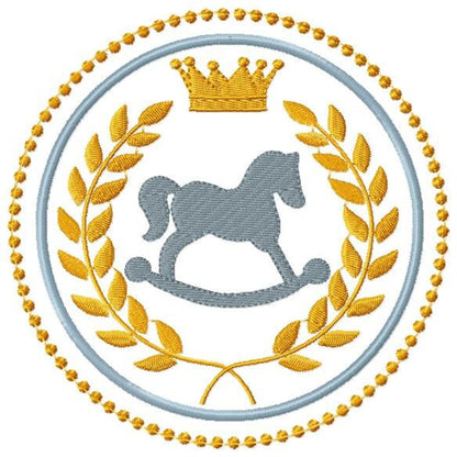 Close-up rocking horse embroidery design, visible fill-stitch texture, gray horse with gold crown and laurel, elegant monogram frame