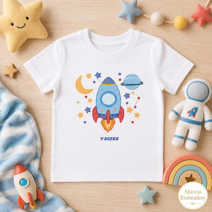 White toddler tee with playful rocket ship embroidery design, blue rocket, stars, moon
