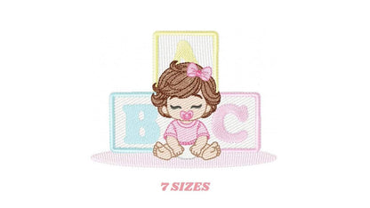 Small preview, baby girl embroidery design with brown wavy hair, pink bow, pacifier, pastel ABC blocks