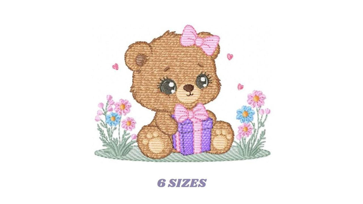 Small full view of baby girl teddy bear on grass with purple gift, birthday teddy bear embroidery design shown in six sizes