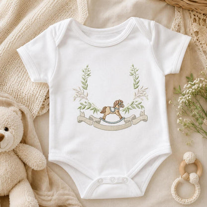 White baby bodysuit styled with cradle animals and floral frame, baby bodysuit embroidery pattern in cottagecore pastels