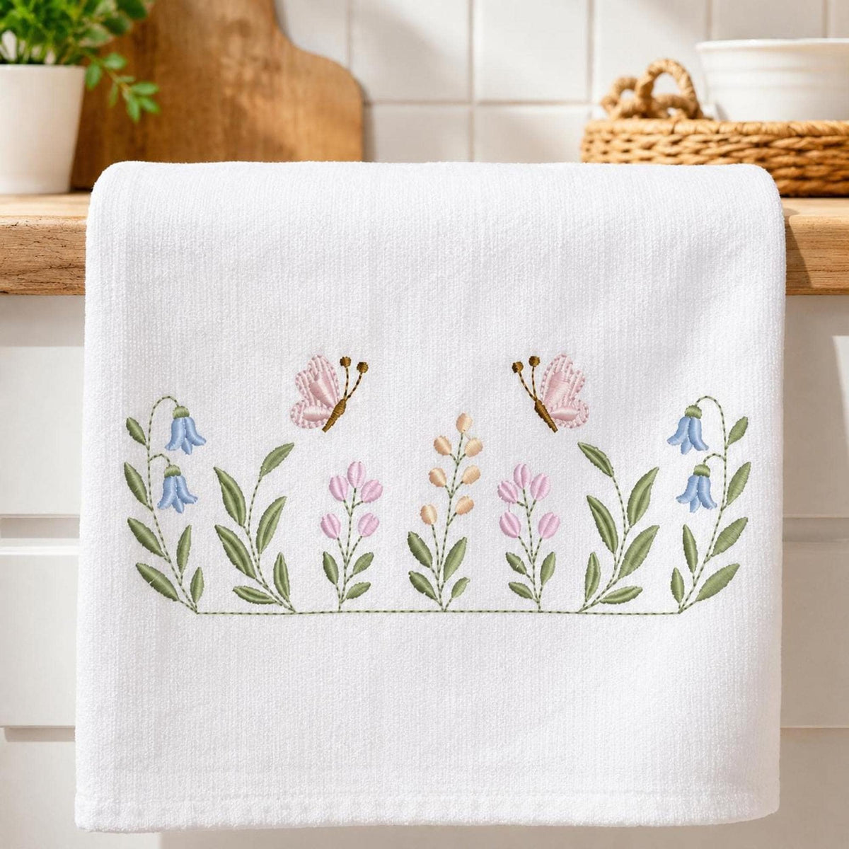 Wide towel display with stitched wildflower border, mixed blooms and butterflies, floral embroidery files shown