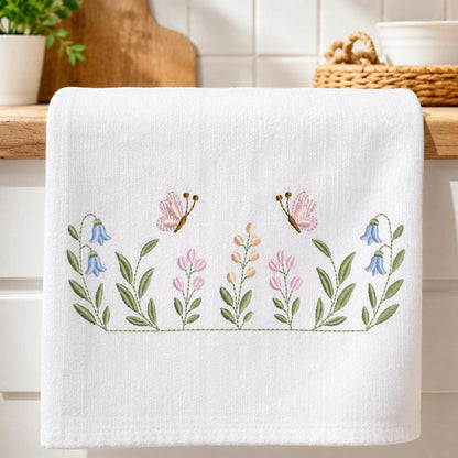Wide towel display with stitched wildflower border, mixed blooms and butterflies, floral embroidery files shown